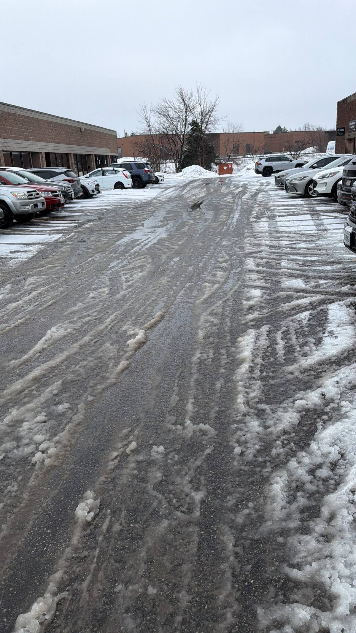 Commercial plaza parking lot on 14th Avenue in Markham plowed and salted by ISR Gardening