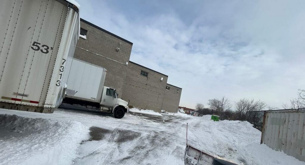 Commercial lot and loading docks plowed by an ISR Gardening truck after a snowfall