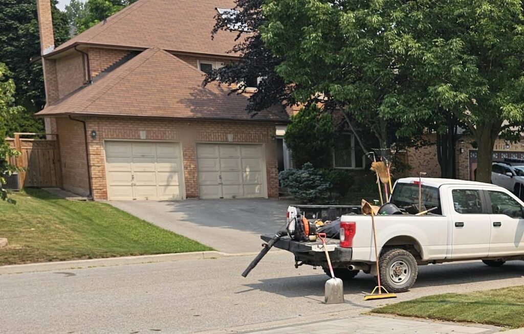 ISR Gardening work truck loaded with tools at a Richmond Hill job site