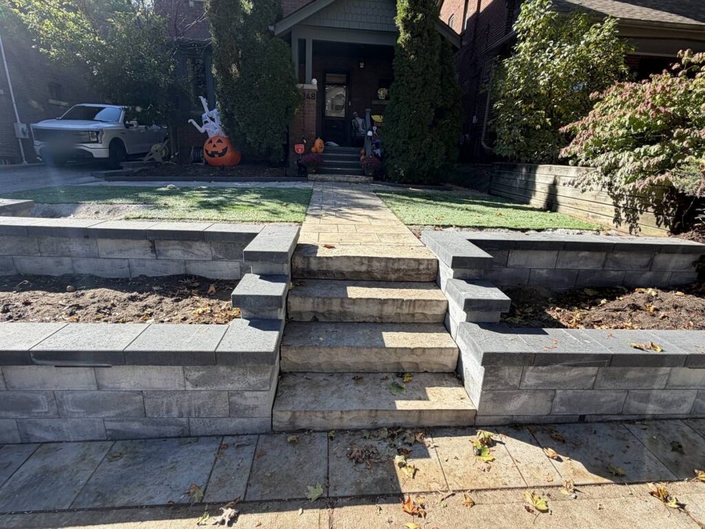 New interlocking front steps between two raised stone planters in Toronto