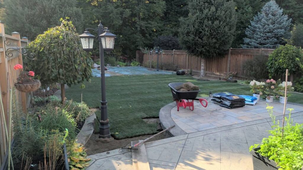 Finished new sod back lawn around a stone patio in Vaughan
